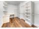Spacious walk-in closet with built in desk and shelves and wood floors at 426 Saint Michaels Way, Fort Mill, SC 29708
