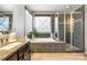 Bright bathroom featuring a soaking tub beneath a window and a glass-enclosed shower at 487 Hawks Creek Pkwy, Fort Mill, SC 29708