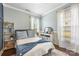 Serene bedroom featuring neutral paint, plush bedding, and natural light from large windows at 487 Hawks Creek Pkwy, Fort Mill, SC 29708