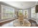 Bright dining area featuring hardwood floors, large windows, and a stylish chandelier at 487 Hawks Creek Pkwy, Fort Mill, SC 29708