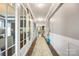 Elegant hallway with hardwood floors, paneled walls, stylish lighting, and glass doors at 487 Hawks Creek Pkwy, Fort Mill, SC 29708
