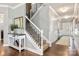 Inviting foyer with hardwood floors, staircase, console table, and elegant decor for a warm welcome at 487 Hawks Creek Pkwy, Fort Mill, SC 29708