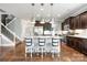 Spacious kitchen island featuring pendant lighting, bar stools, and stainless steel appliances at 487 Hawks Creek Pkwy, Fort Mill, SC 29708