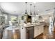 Open-concept kitchen featuring stainless appliances, granite countertops and a view to the living and dining areas at 487 Hawks Creek Pkwy, Fort Mill, SC 29708