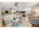 Open concept living room with hardwood floors, ceiling fan, and access to the kitchen and dining areas at 487 Hawks Creek Pkwy, Fort Mill, SC 29708
