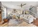 Bright, inviting living room featuring stylish decor, a ceiling fan, and access to a staircase at 487 Hawks Creek Pkwy, Fort Mill, SC 29708