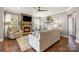 Comfortable living room featuring a stone fireplace, neutral decor, and hardwood floors at 487 Hawks Creek Pkwy, Fort Mill, SC 29708