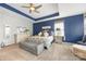 Comfortable main bedroom with a tray ceiling, accent wall, plush carpet, and large windows for ample sunlight at 487 Hawks Creek Pkwy, Fort Mill, SC 29708