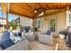Covered patio area features a ceiling fan, comfortable seating, and hot tub at 487 Hawks Creek Pkwy, Fort Mill, SC 29708