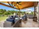 Spacious covered patio with outdoor furniture, hot tub and adjacent landscaped backyard at 487 Hawks Creek Pkwy, Fort Mill, SC 29708