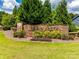 Community entrance sign amidst lush landscaping, showcasing the name Hawk's Creek on a stone wall at 487 Hawks Creek Pkwy, Fort Mill, SC 29708