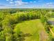 Aerial view of a large green grass field surrounded by dense tree coverage at 4896 Pageland Hwy, Lancaster, SC 29720