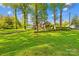 Beautiful backyard showcasing a large lawn, landscaping, and patio area for enjoying the outdoors at 4896 Pageland Hwy, Lancaster, SC 29720