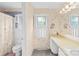 Neutral-toned bathroom features floral wallpaper, a toilet, and a vanity at 4896 Pageland Hwy, Lancaster, SC 29720