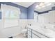 Well lit bathroom features a white vanity and fixtures with a large window with an exterior view at 4896 Pageland Hwy, Lancaster, SC 29720