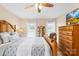 Comfortable bedroom with a decorative wooden bed frame and sun-lit windows at 4896 Pageland Hwy, Lancaster, SC 29720