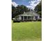Inviting home exterior features a covered porch and a well-manicured lawn with blossoming plants at 4896 Pageland Hwy, Lancaster, SC 29720