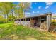 View of the horse barn with multiple stalls, doors, and hay at 4896 Pageland Hwy, Lancaster, SC 29720