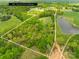 Aerial view of a large property with a pond and wooded area, approximate lot lines shown at 4896 Pageland Hwy, Lancaster, SC 29720
