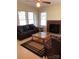 Cozy living room with a brick fireplace, natural light from large windows, and comfortable seating at 4896 Pageland Hwy, Lancaster, SC 29720