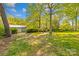 View of a grass backyard featuring various trees and outbuildings at 4896 Pageland Hwy, Lancaster, SC 29720