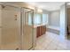 Spacious bathroom features a glass shower, soaking tub, and plenty of counter space at 5104 Shannamara Dr, Matthews, NC 28104