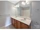 Bathroom featuring double vanity with a large mirror, good lighting, and a neutral color scheme at 5104 Shannamara Dr, Matthews, NC 28104