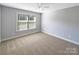 Clean bedroom with carpet, a window with natural light, and neutral paint at 5104 Shannamara Dr, Matthews, NC 28104