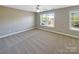Cozy bedroom with neutral carpeting and large windows, offering a comfortable and bright living space at 5104 Shannamara Dr, Matthews, NC 28104