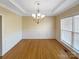 Elegant dining room with hardwood floors, a chandelier, and large windows, perfect for formal gatherings at 5104 Shannamara Dr, Matthews, NC 28104