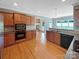 Modern kitchen with stainless steel appliances, granite countertops, and hardwood floors at 5104 Shannamara Dr, Matthews, NC 28104