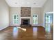 Bright living room with stone fireplace, hardwood floors, and natural light at 5104 Shannamara Dr, Matthews, NC 28104