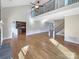 Open-concept living room with hardwood floors, a soaring ceiling, and an adjacent kitchen, creating a spacious atmosphere at 5104 Shannamara Dr, Matthews, NC 28104