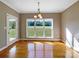 Bright room with hardwood floors and large windows overlooking a green backyard, providing a serene view at 5104 Shannamara Dr, Matthews, NC 28104
