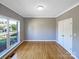 Bright room featuring hardwood floors, a large window, and a closet, offering ample natural light and storage space at 5104 Shannamara Dr, Matthews, NC 28104