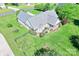 An aerial view shows the roof, sunroom, and landscaped yard of the home and property at 557 Luther Dr, Iron Station, NC 28080