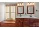 Elegant bathroom features dual vanities, wood cabinetry, and custom mirrors at 557 Luther Dr, Iron Station, NC 28080