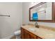 Bright bathroom featuring a marble vanity top and a framed mirror at 557 Luther Dr, Iron Station, NC 28080