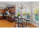 Sunlit breakfast nook features a chandelier and views of the lush backyard at 557 Luther Dr, Iron Station, NC 28080