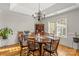 Traditional dining room with wainscoting, wood table, and chandelier lighting at 557 Luther Dr, Iron Station, NC 28080