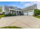 Charming home featuring a welcoming front porch and a two-car garage, set against a manicured lawn at 557 Luther Dr, Iron Station, NC 28080