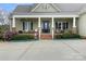 Charming front porch with brick accents and comfortable seating area at 557 Luther Dr, Iron Station, NC 28080