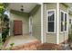 Inviting covered front porch with brick accents and a charming storage cabinet at 557 Luther Dr, Iron Station, NC 28080