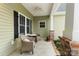 Inviting front porch with seating area, ceiling fan, and charming details. Perfect for relaxing outdoors at 557 Luther Dr, Iron Station, NC 28080
