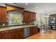 Updated kitchen features wood cabinets, granite countertops, and stainless appliances at 557 Luther Dr, Iron Station, NC 28080