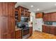 Traditional kitchen with custom cabinetry, stainless steel appliances, and hardwood floors at 557 Luther Dr, Iron Station, NC 28080