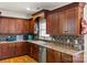 Gourmet kitchen showcases beautiful wood cabinets, granite counters, and stainless steel dishwasher at 557 Luther Dr, Iron Station, NC 28080