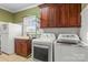 Bright laundry room featuring a sink, cabinets, washer, and dryer at 557 Luther Dr, Iron Station, NC 28080