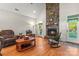 Cozy living room boasts stone fireplace, hardwood floors, and a rocking chair at 557 Luther Dr, Iron Station, NC 28080