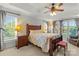 Serene main bedroom with large windows, tray ceilings, and a comfortable seating area at 557 Luther Dr, Iron Station, NC 28080